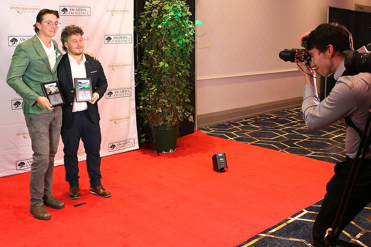 two people on the red carpet posing for a photographer