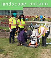 people looking at a lawnmower